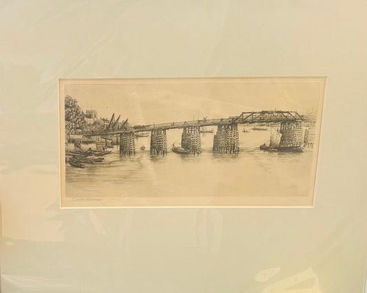 Monochrome etching by Walter W. Burgess showing a riverside scene with wooden pier, small boats, and background buildings, c.1890s Old Putney Bridge
