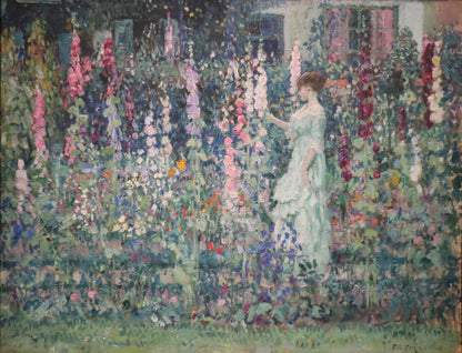 American Vintage Impressionist Wall Art Print depicting a lady in a summer garden amid spires of purple and pink Hollyhock Flowers.  Originally created in the &nbsp;early 20th Century this enchanting print from an original impressionist artwork by Carl Frieseke &nbsp;combines the essence of the era. The lady admires the beautiful tall flower spikes blooming in summer. &nbsp;The subtle pink purple tones and muted colour palette will endow any room with a sense of calmness and tranquillity.